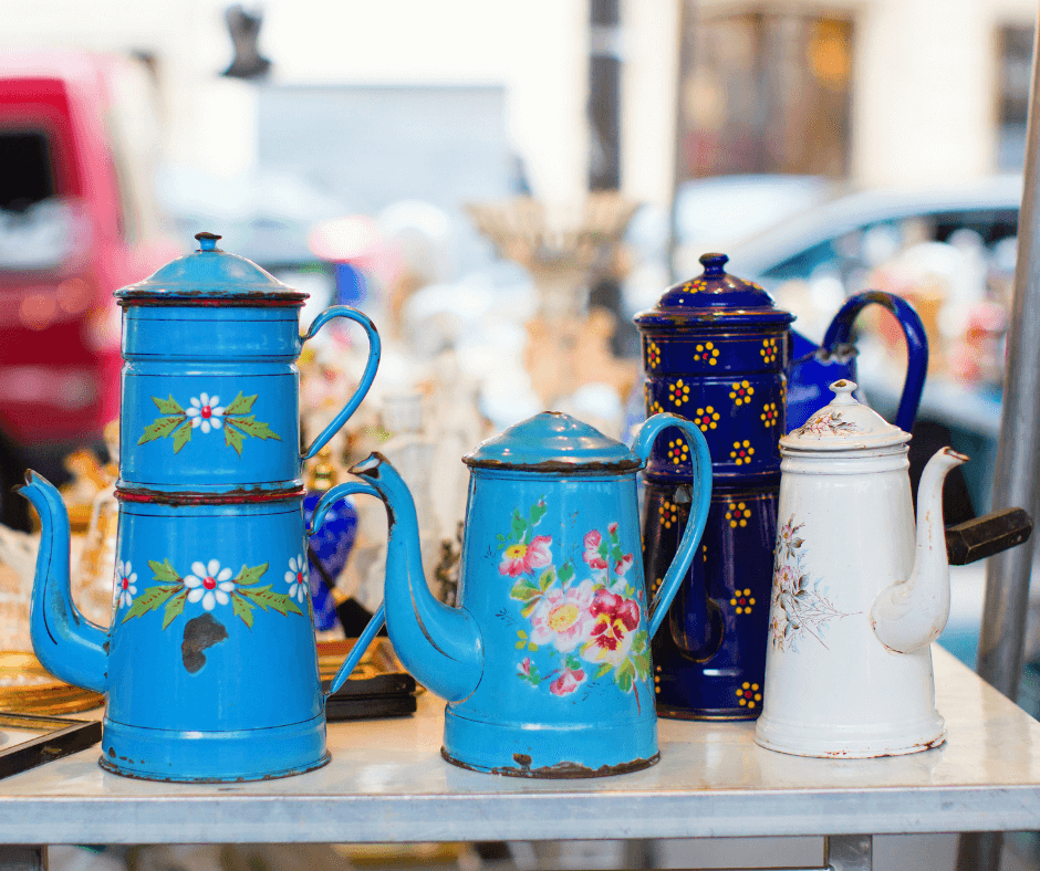 A group of blue tea pots on a table.