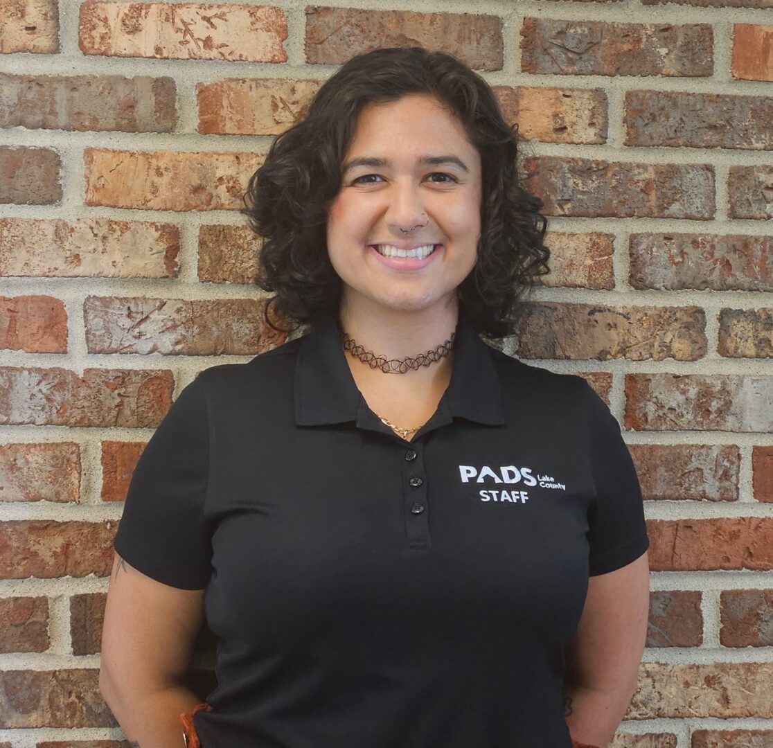 Smiling woman in black staff shirt.